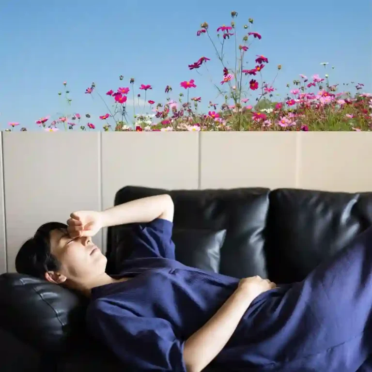 Person lying in bed experiencing vertigo as the room appears to spin, illustrating positional dizziness that can happen when lying down or rolling over in bed.